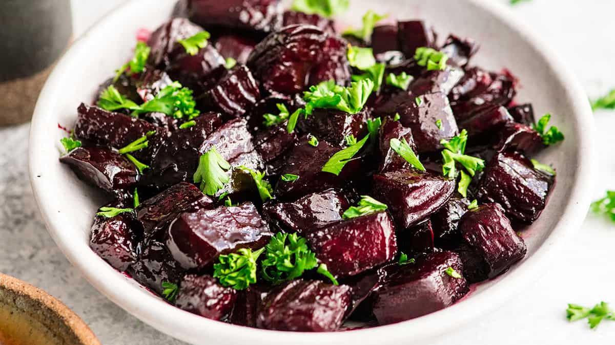 a bowl of Balsamic Roasted Beets garnished with greens