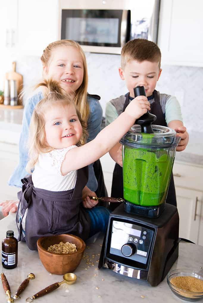 front view of three kids blending in a blender in this article about Front view of a mom and her four kids blending in a blender while she's Cooking with Kids