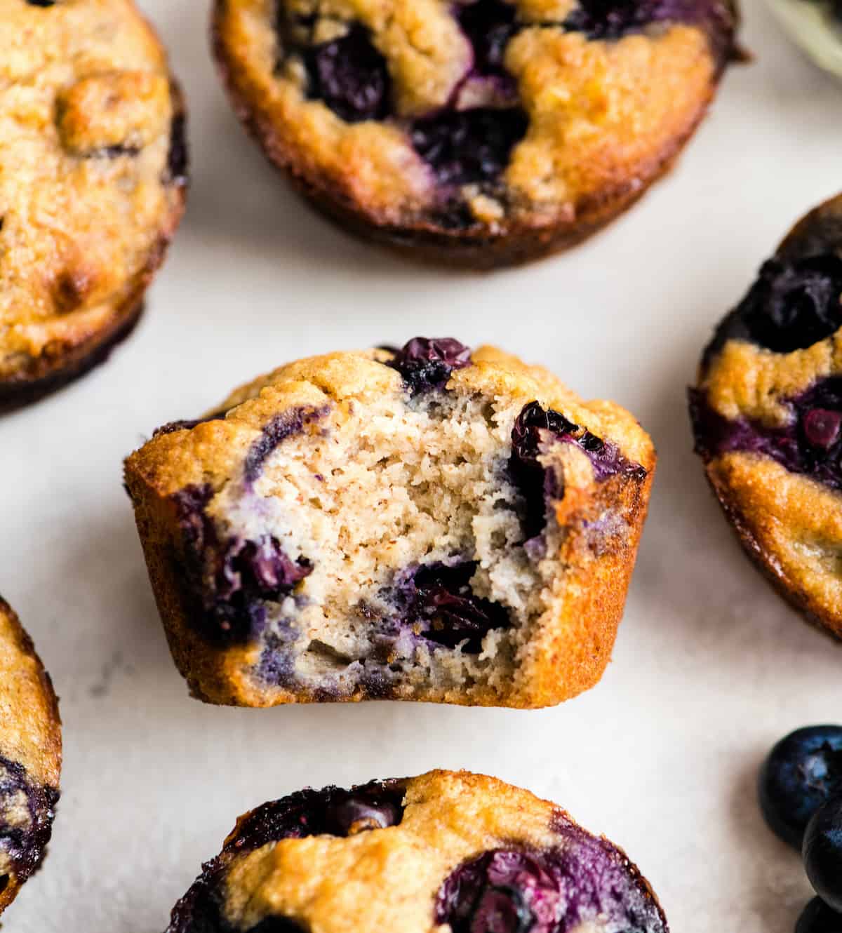 overhead view of a Paleo Blueberry Muffin with a bite taken out of it