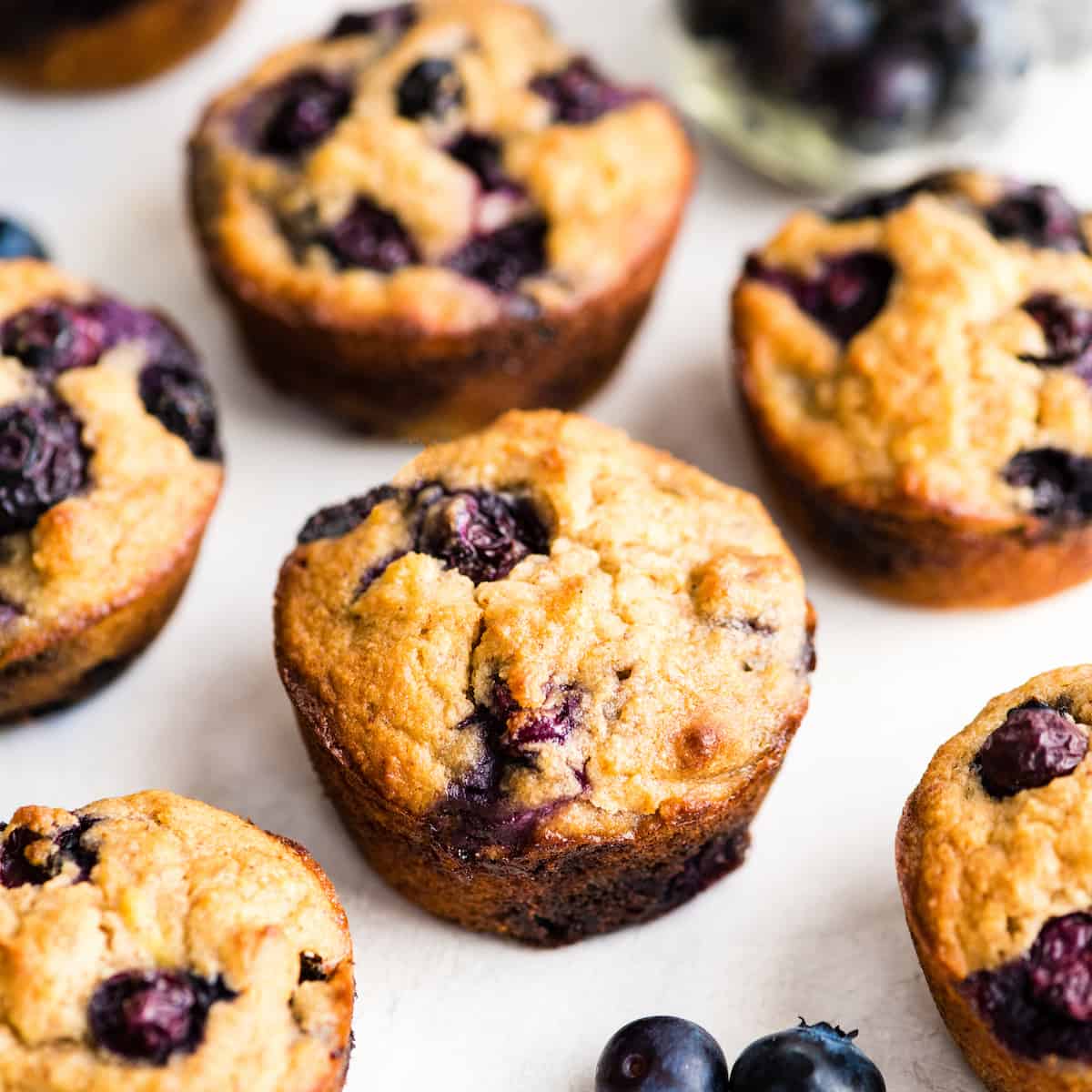 6 Paleo Blueberry Muffins on a white surface