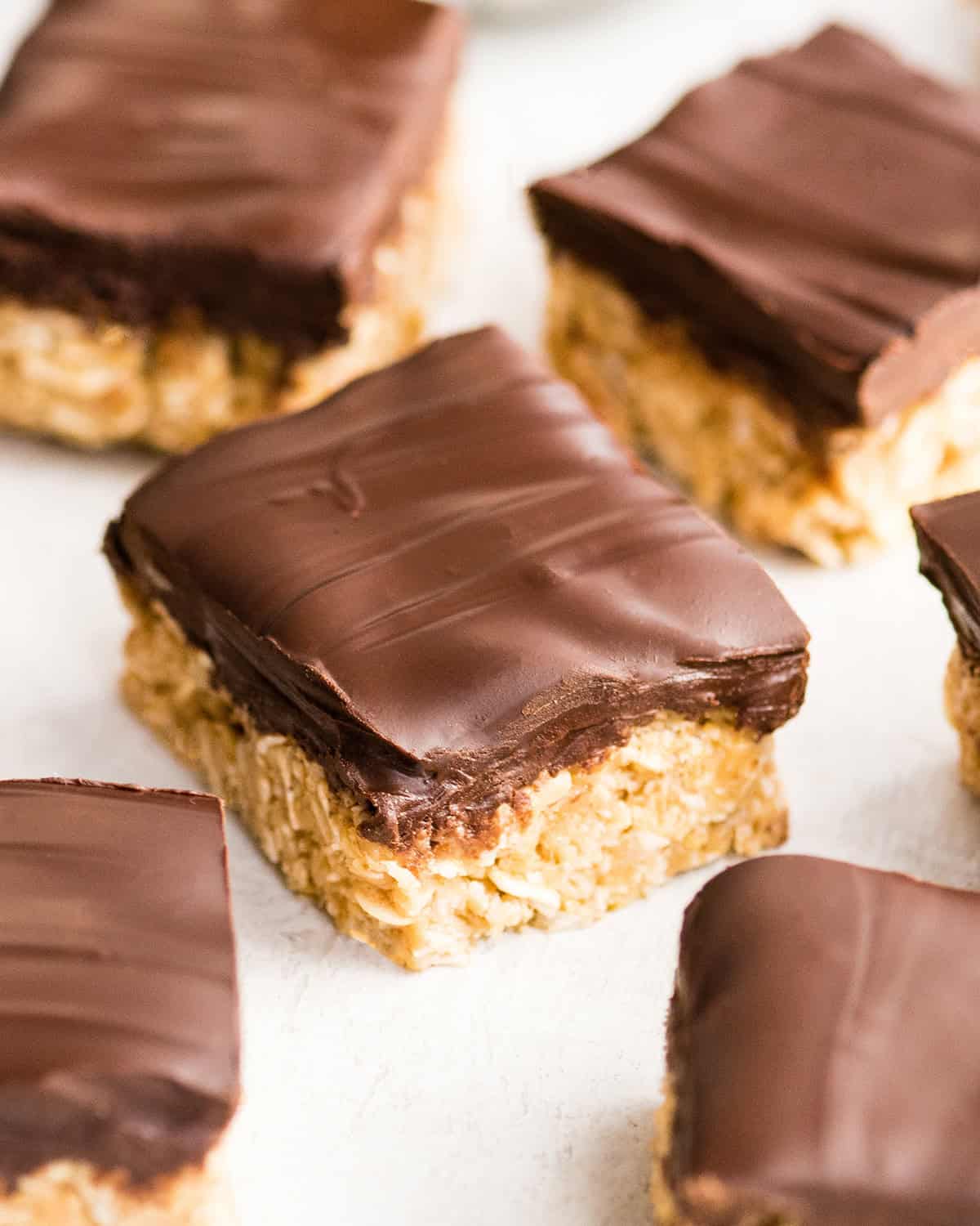 5 No Bake Oatmeal Bars with peanut butter and chocolate on top