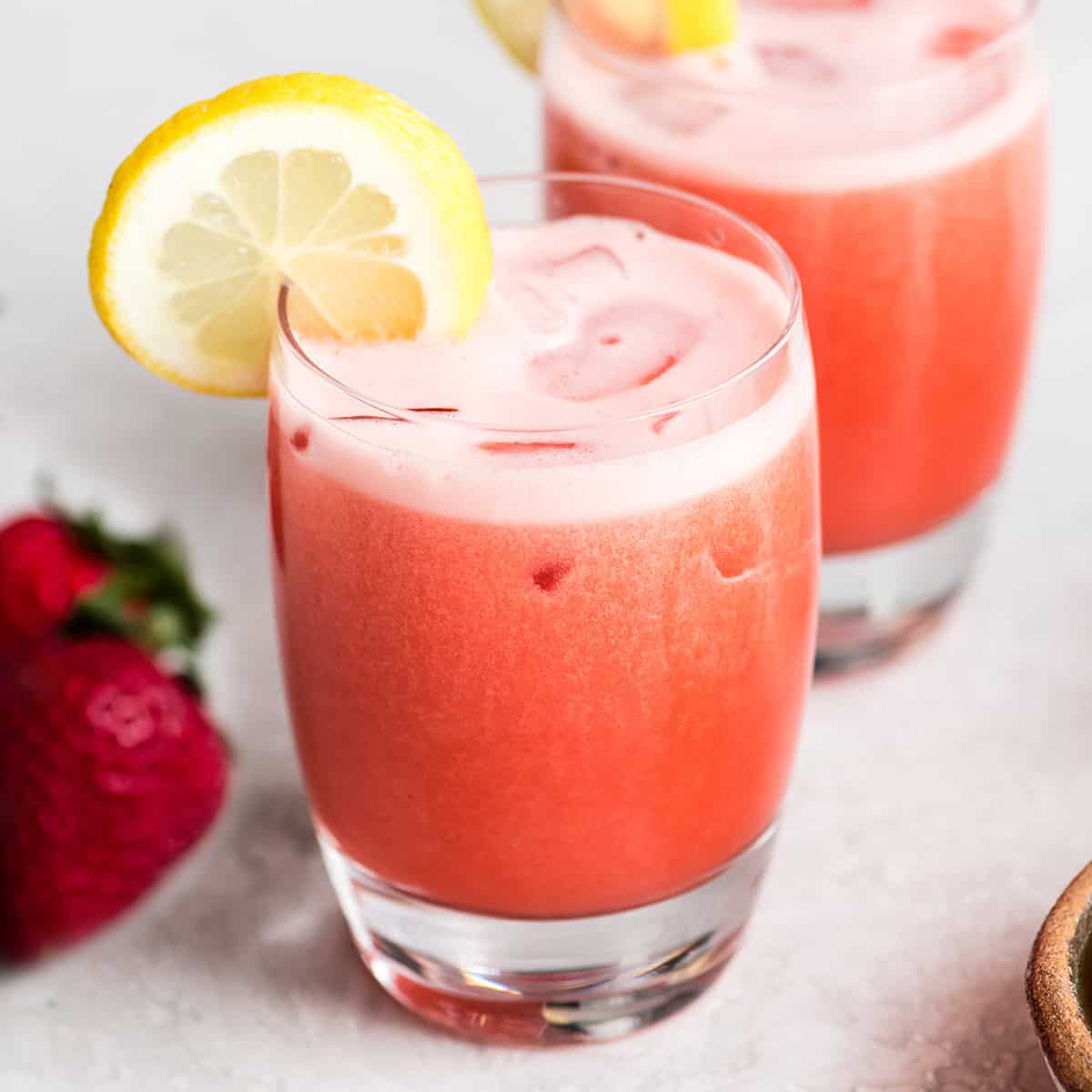 two glasses of Homemade Strawberry Lemonade with ice 