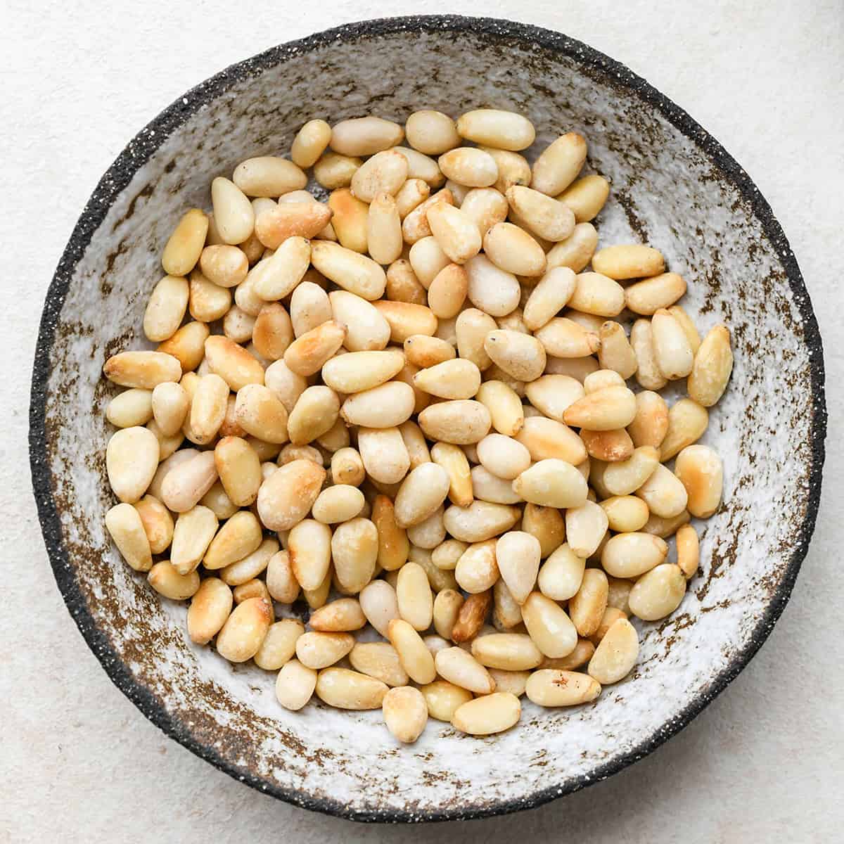 How to Make Pesto Sauce - toasted pine nuts in a bowl