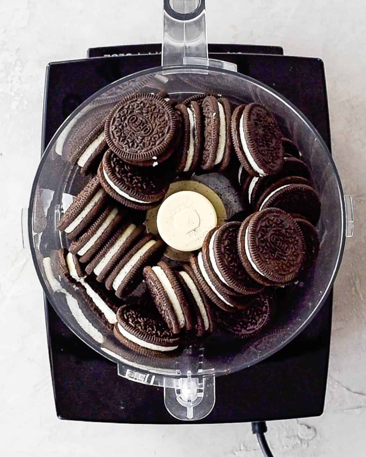 making oreo dirt cake recipe - full oreos in a food processor fitted with the "S" attachment before processing