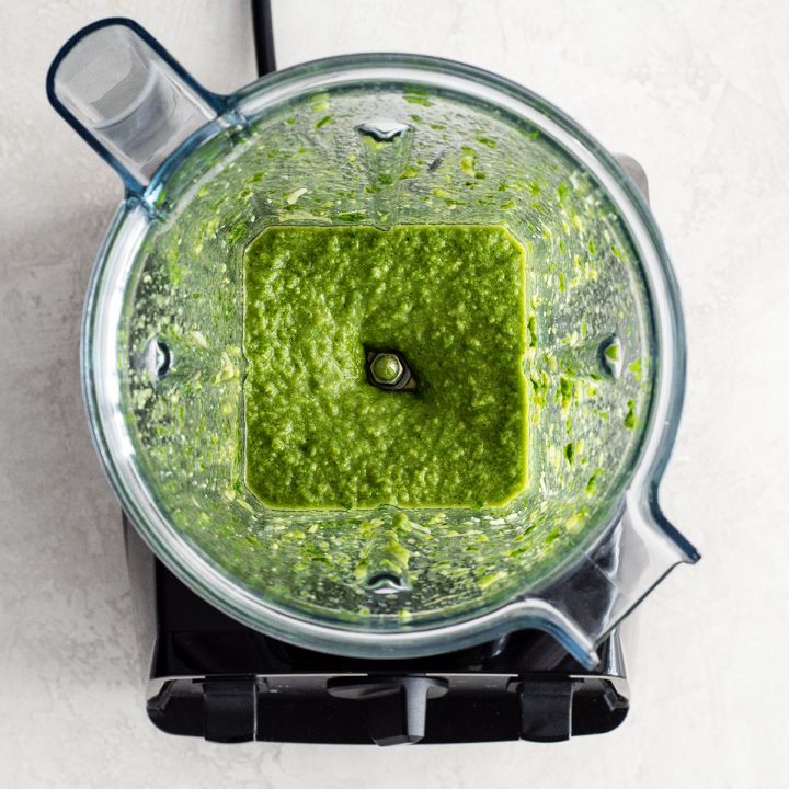 overhead view of the final Basil Pesto Sauce Recipe after it has finished blending in the blender container