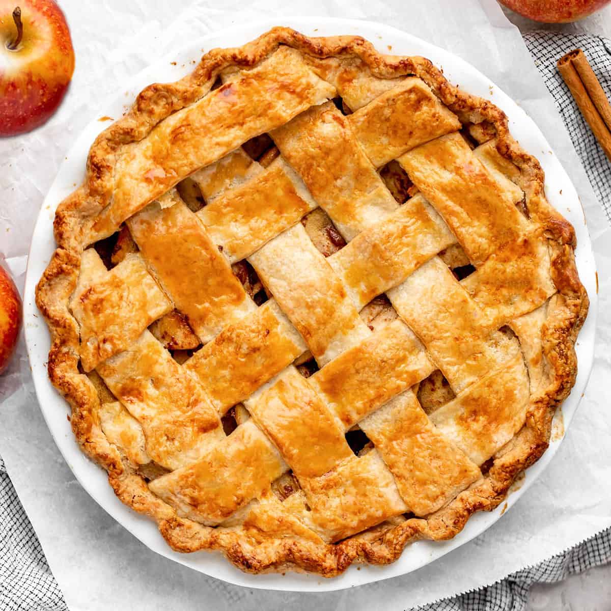 baked apple pie in a pie dish with a lattice crust