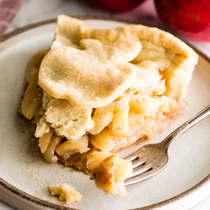 Front view of a slice of apple pie on a plate