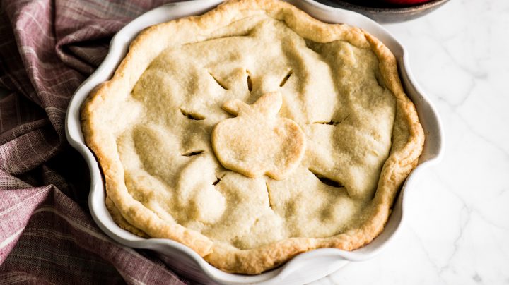 Front view of baked apple pie in a pie dish