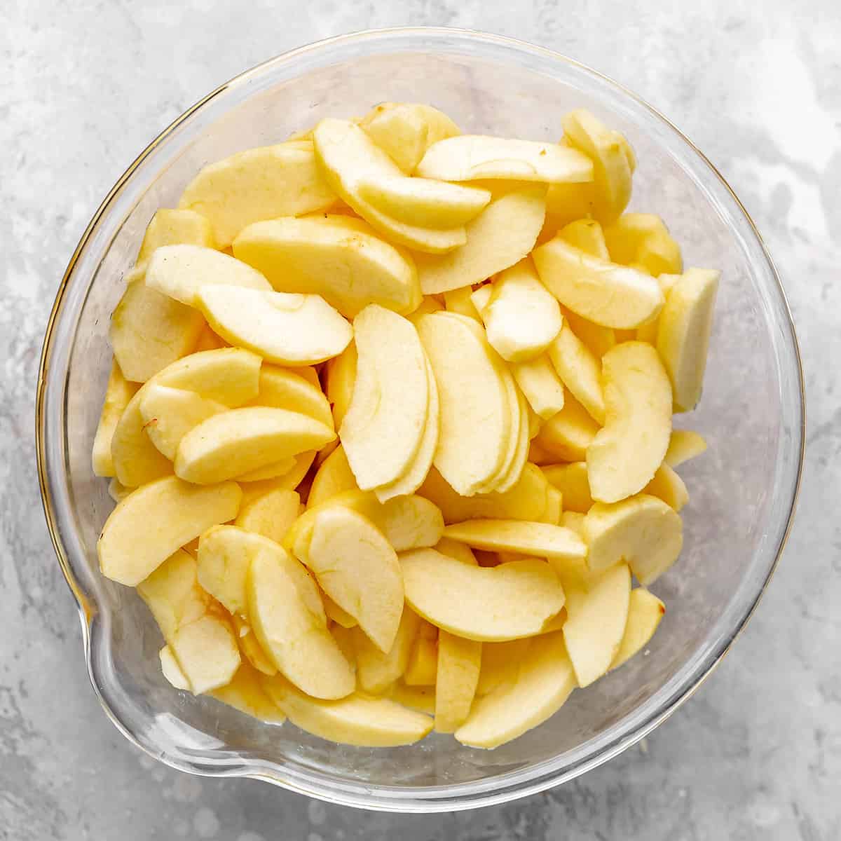How to Make Apple Pie - peeled & sliced apples in a bowl