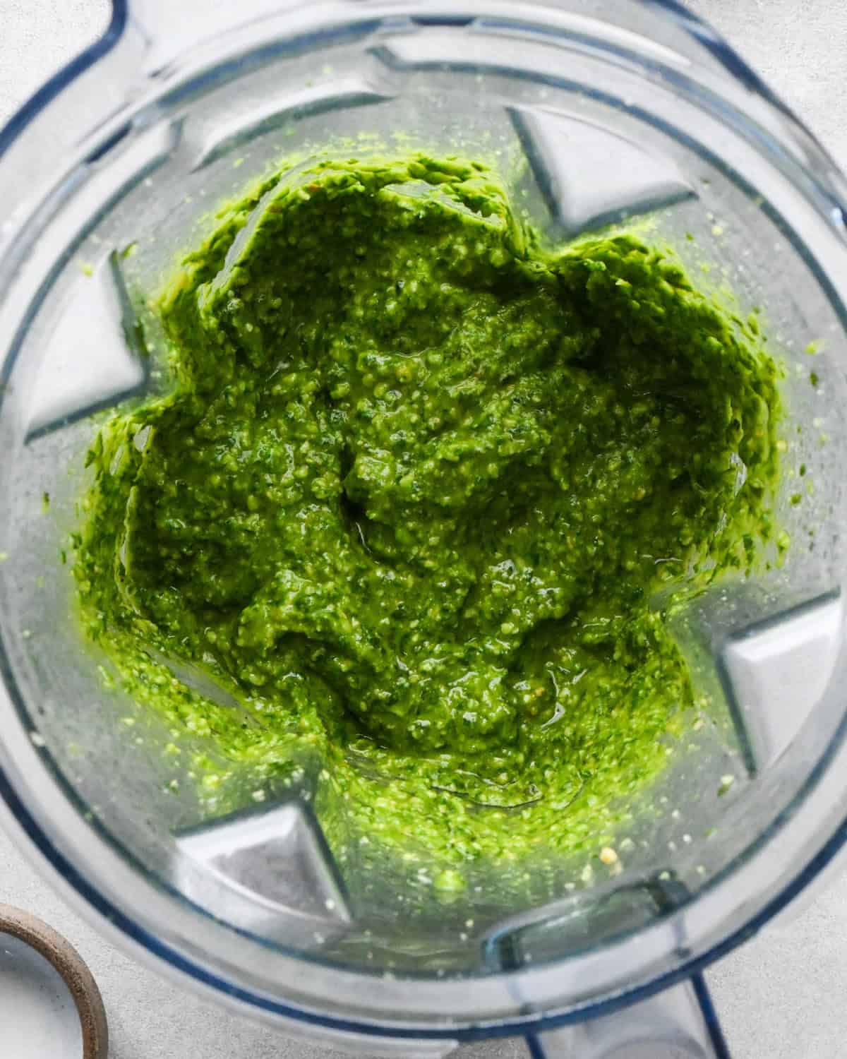 pesto sauce in a blending container after blending to make this pesto and pasta recipe