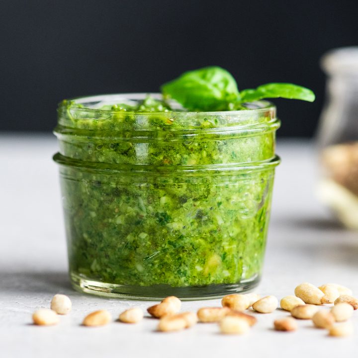 a glass jar filled with homemade pesto sauce