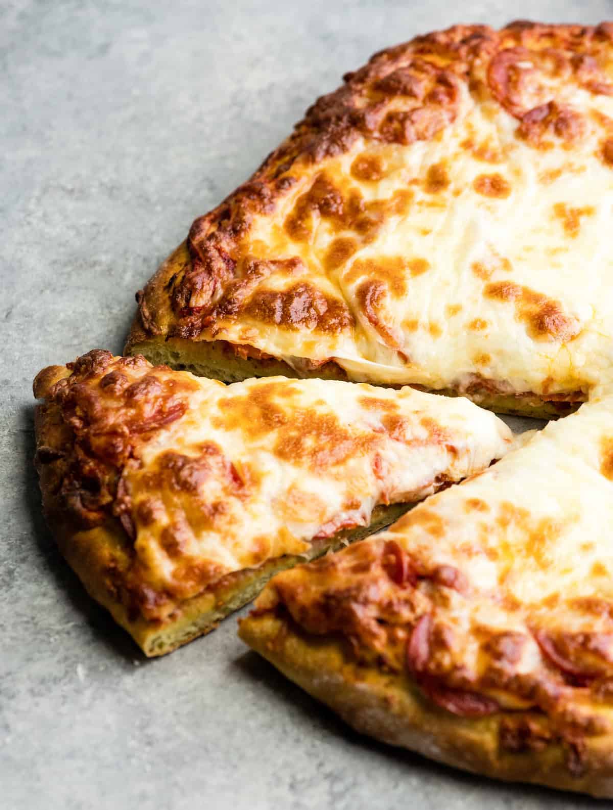 Zucchini Pizza Crust with a piece cut out of the pizza