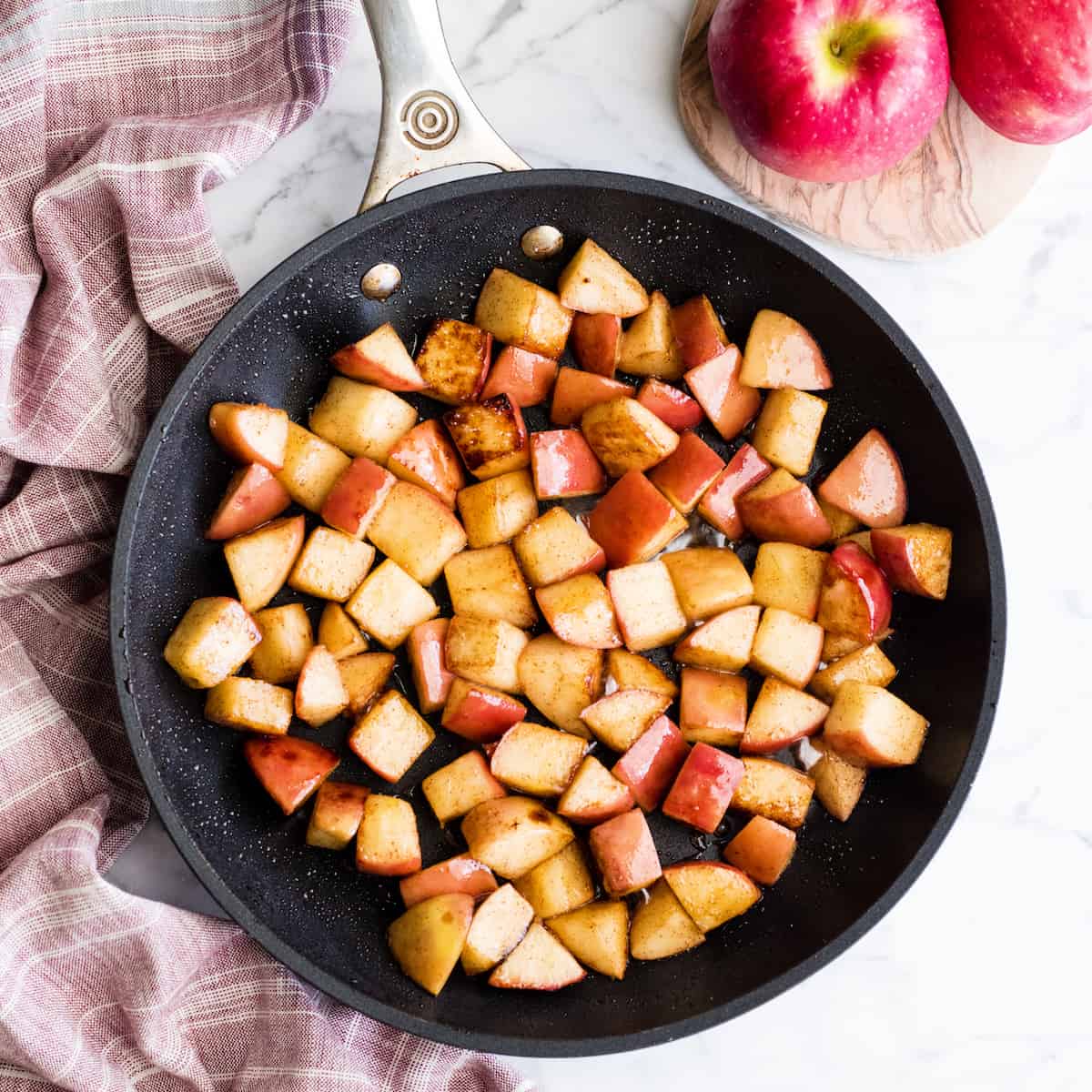 Overhead view of sautéed cinnamon apples in a non-stick fry pan