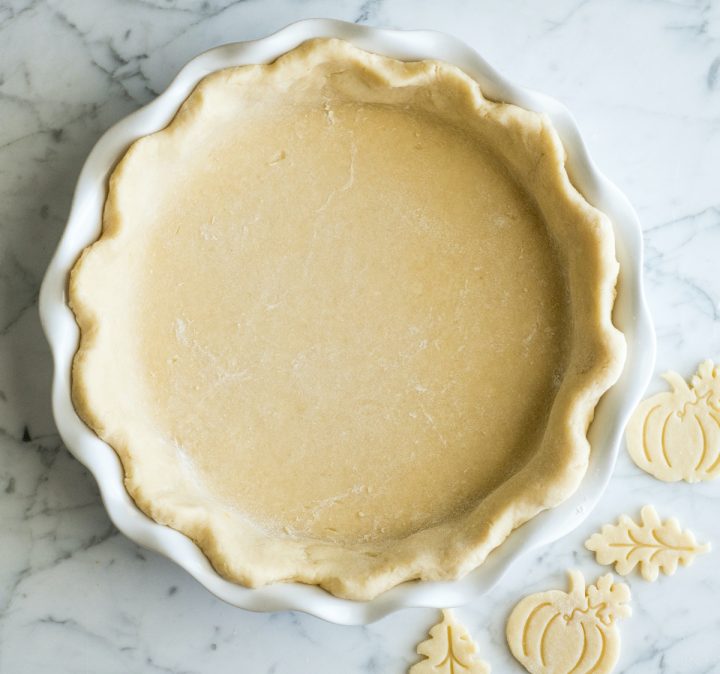 overhead view of a pumpkin pie crust shaped into the pie plate