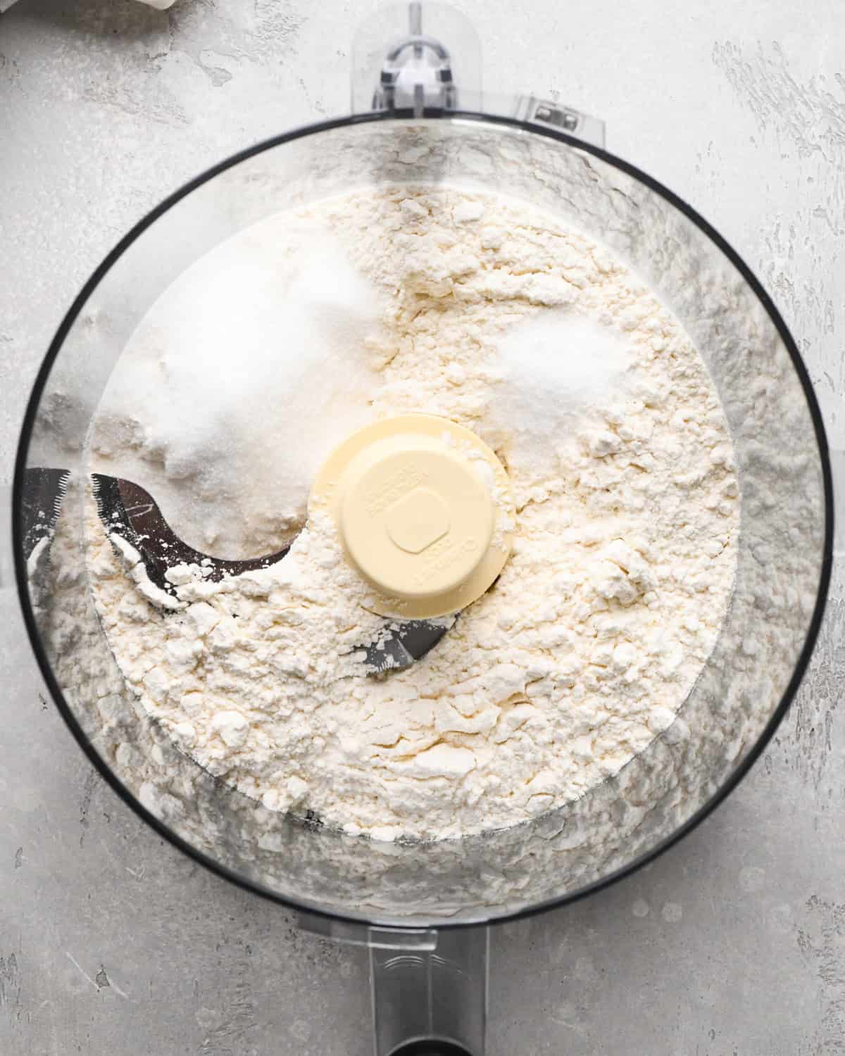 making pumpkin pie crust - flour salt and sugar in a food processor before mixing
