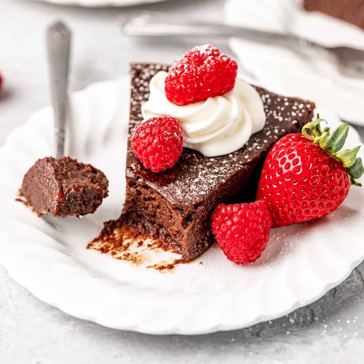 Flourless Chocolate Cake on a plate with a bite taken out