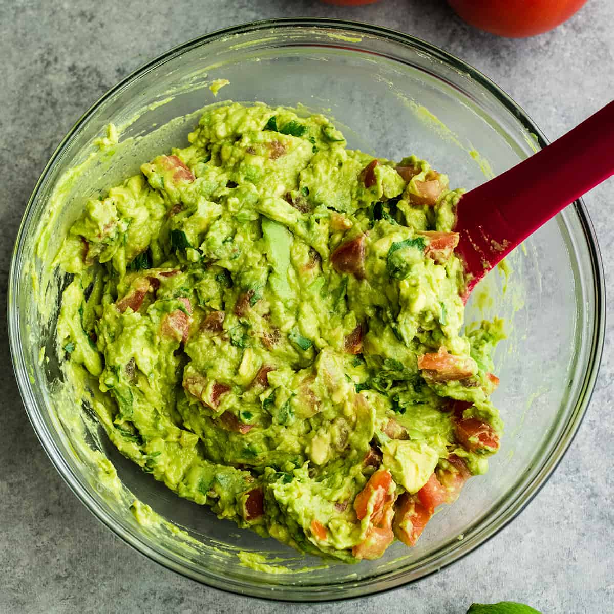 photo showing guacamole mixed in a bowl with a spatula