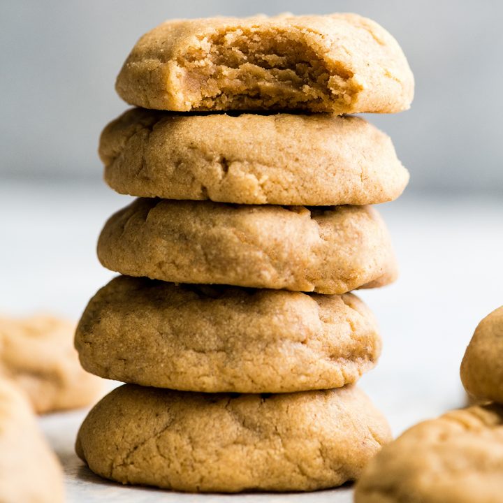 front view of a stack of 5 peanut butter cookies, the top has a bite taken out of it