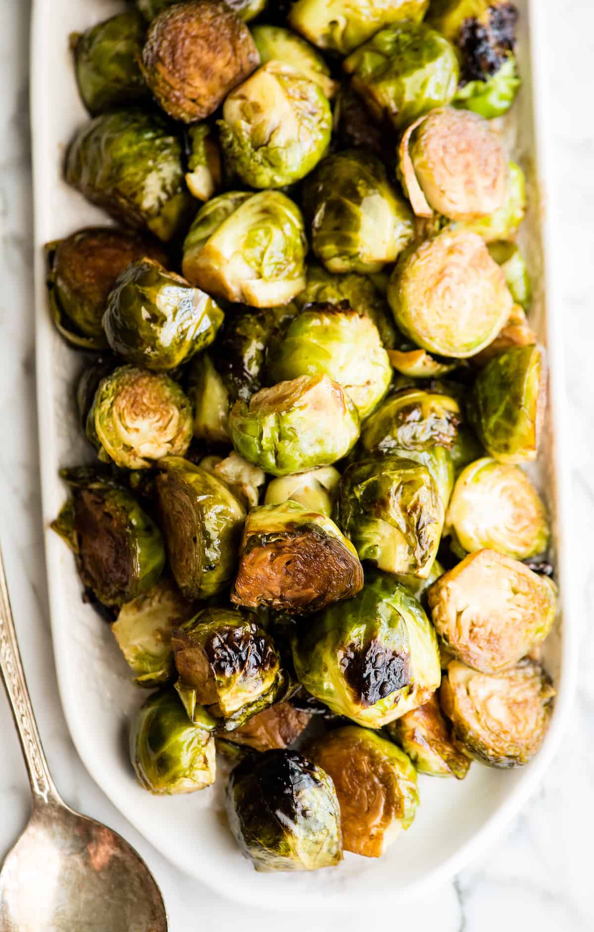 overhead view of balsamic roasted brussel sprouts on a serving dish