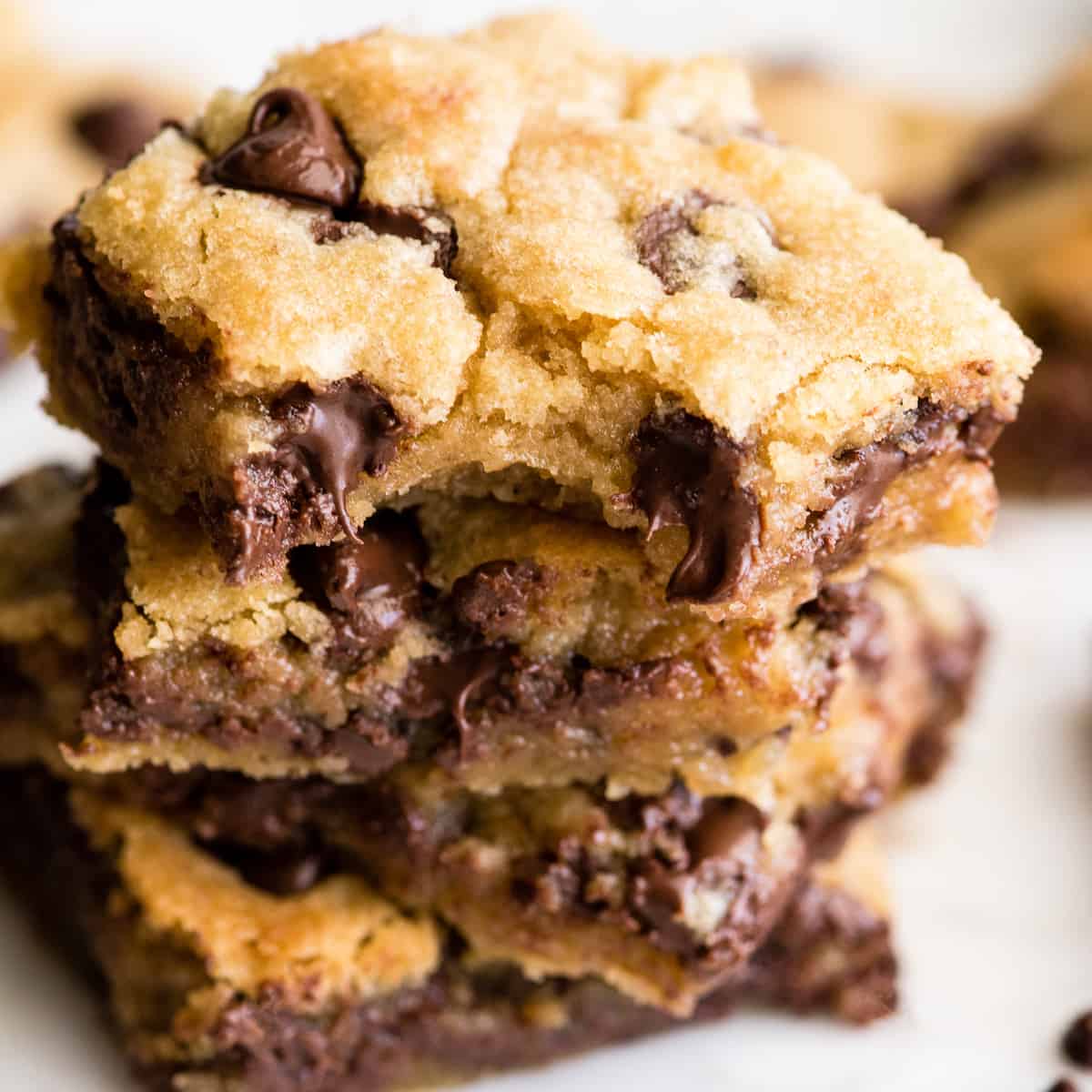 front view of a stack of 4 chocolate chip cookie bars. 