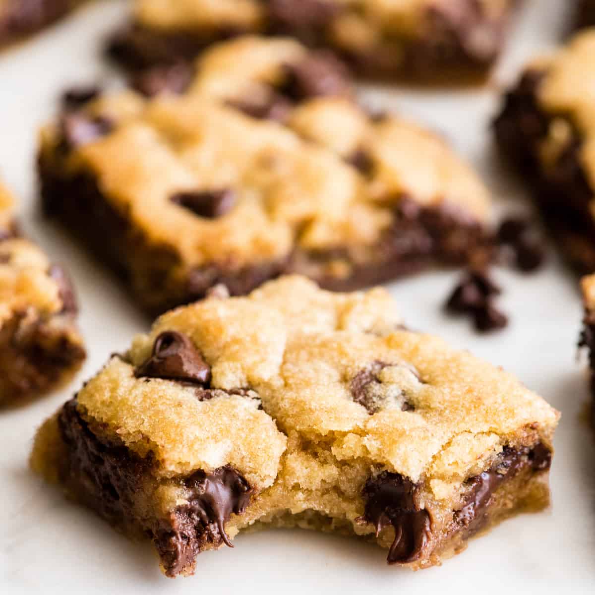 front view of a chocolate chip cookie bar with a bite taken out of it