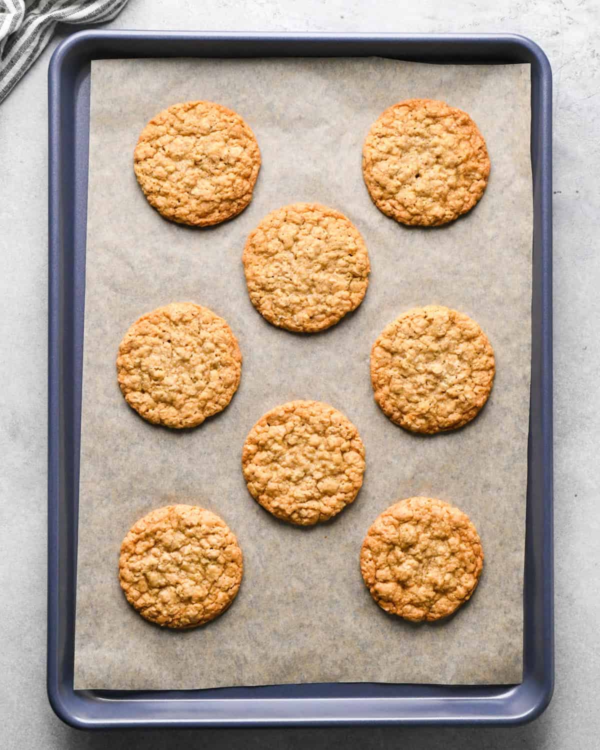 8 oatmeal cookies on a baking sheet lined with parchment paper after baking