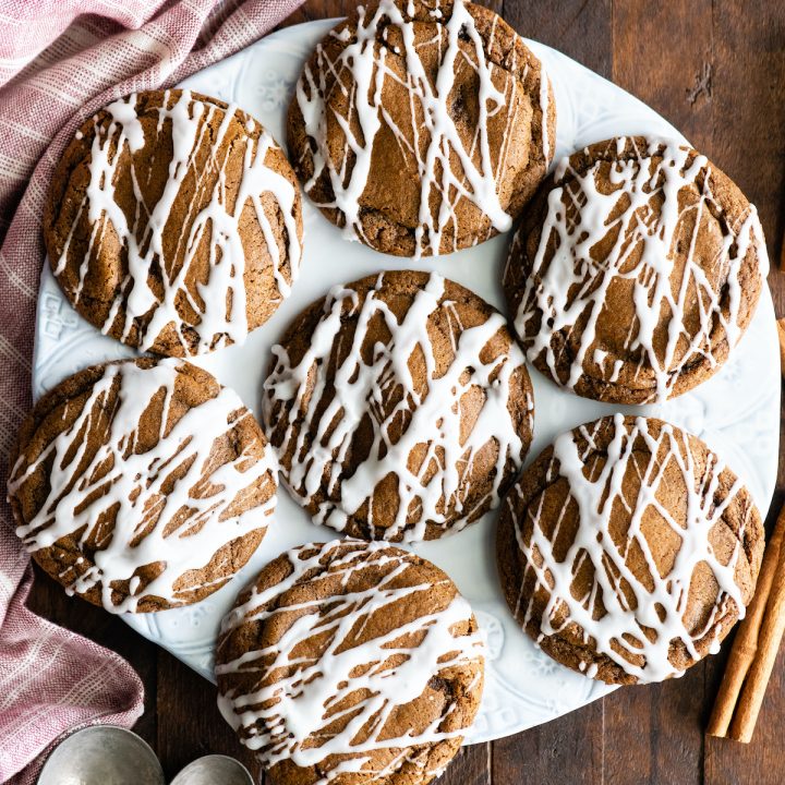 overhead view of a plate of 7 Best Soft Gingerbread Cookies with glaze drizzled on them