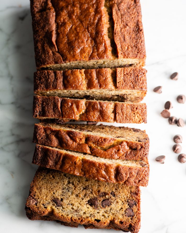 overhead view of a loaf of Chocolate Chip Banana Bread with 5 slices cut out of it