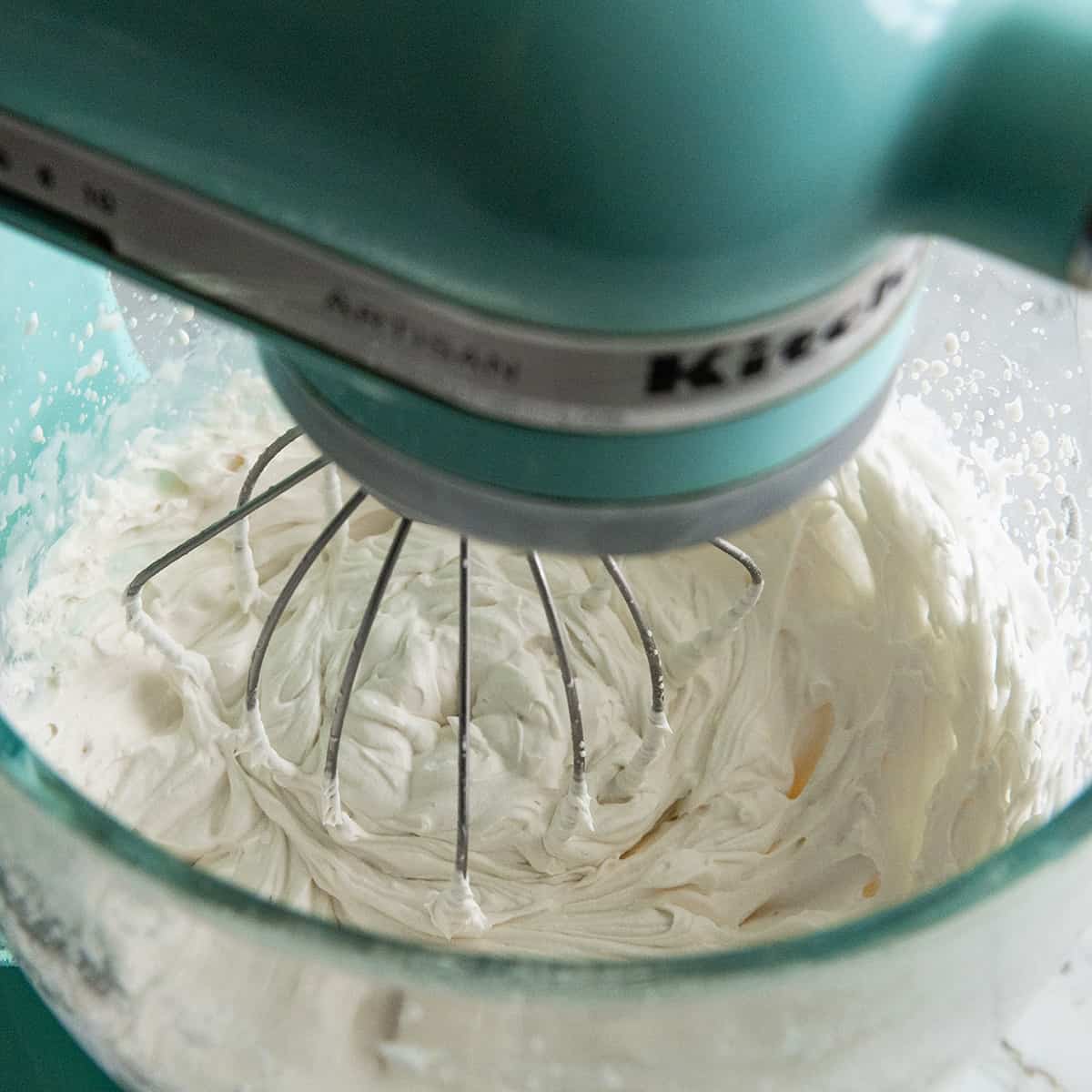 How to Make Whipped Cream - stiff peaks formed in a standing mixer fitted with the wire whisk attachment