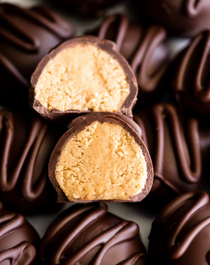 up close overhead view of a No-Bake Chocolate Peanut Butter Ball cut in half sitting on top of other peanut butter balls.