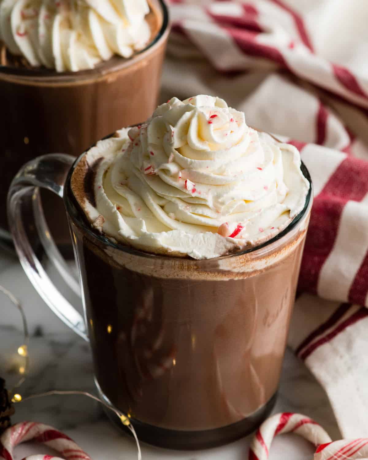 two mugs of peppermint hot chocolate with whipped cream