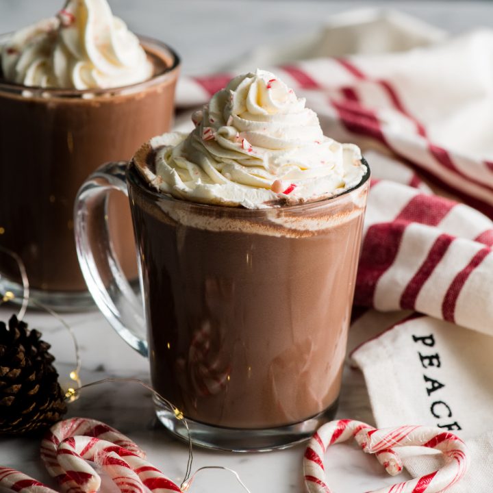 two mugs of peppermint hot chocolate with whipped cream