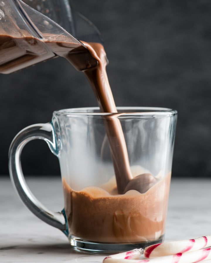 front view of peppermint hot chocolate being poured into a mug