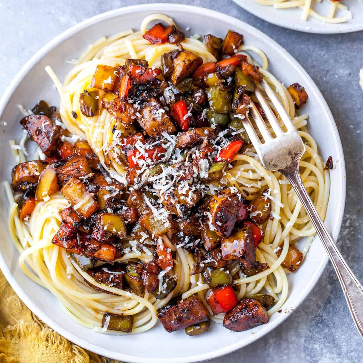 overhead view of chicken sausage and peppers recipe on a plate over pasta