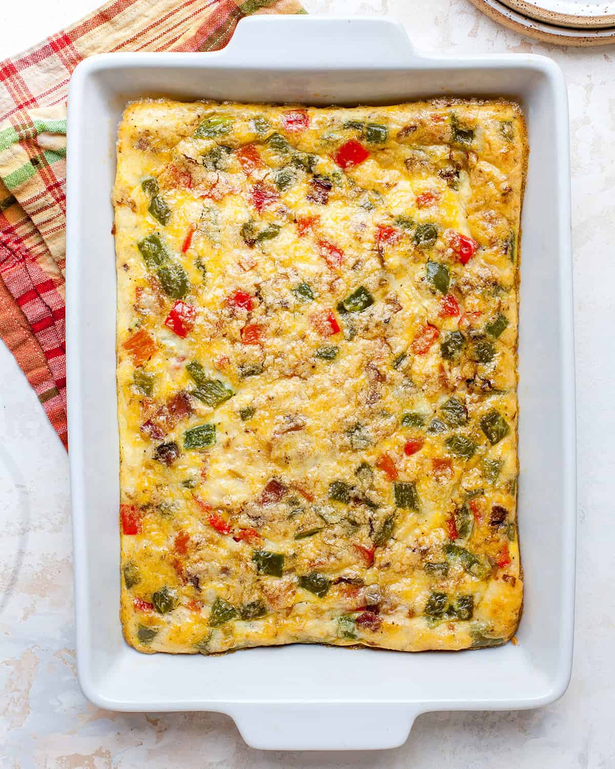 overhead photo of egg casserole in a white baking dish