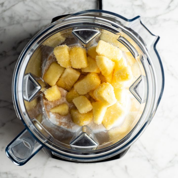 overhead view of how to make a pineapple smoothie in a Vitamix blender