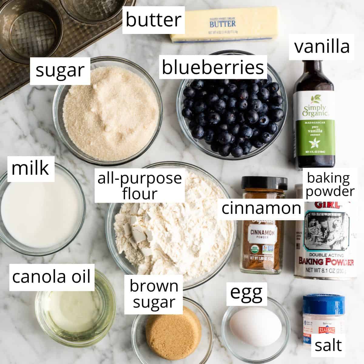 overhead photo of the labeled ingredients in this blueberry muffin recipe