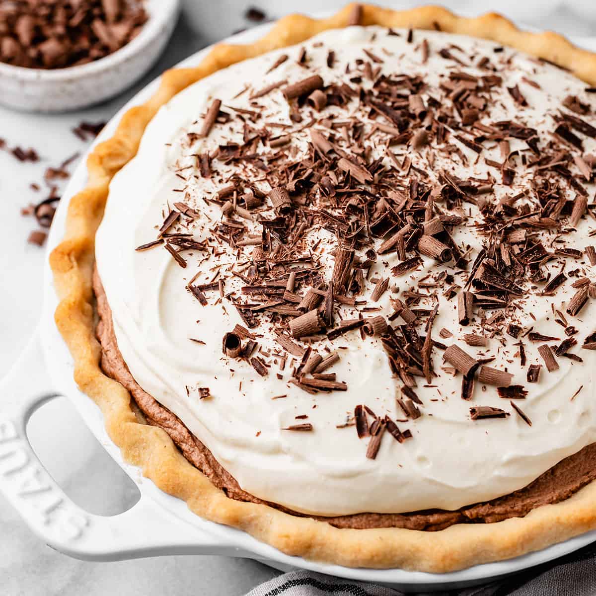 french silk pie topped with whipped cream and chocolate shavings 