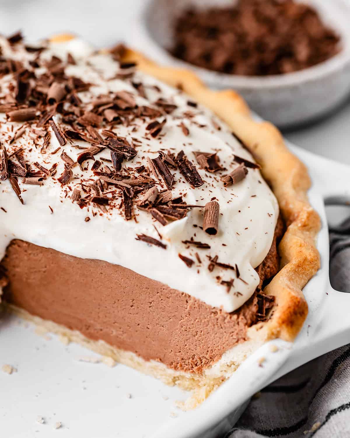 french silk pie in a pie dish with a piece cut out of it