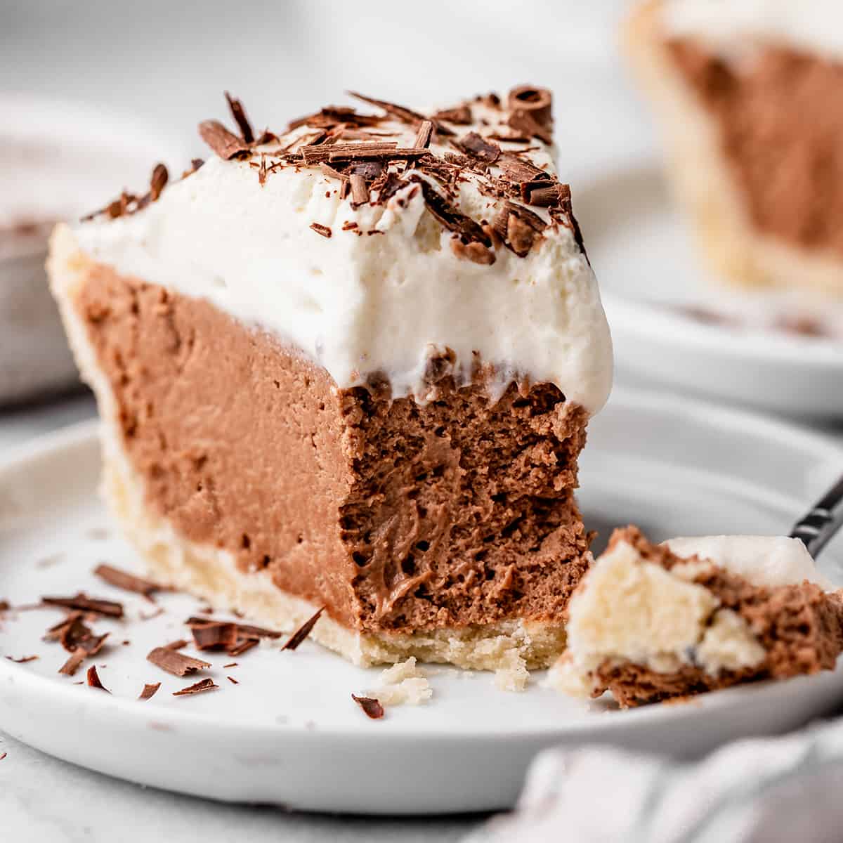 French Silk Pie on a plate with a bite taken out of it