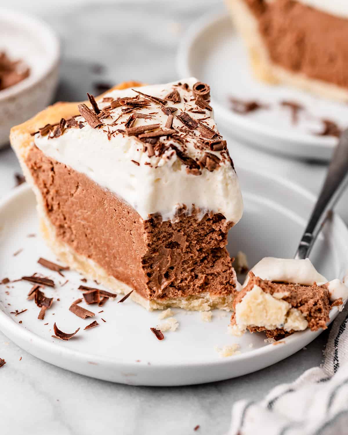 French Silk Pie on a plate with a bite taken out of it