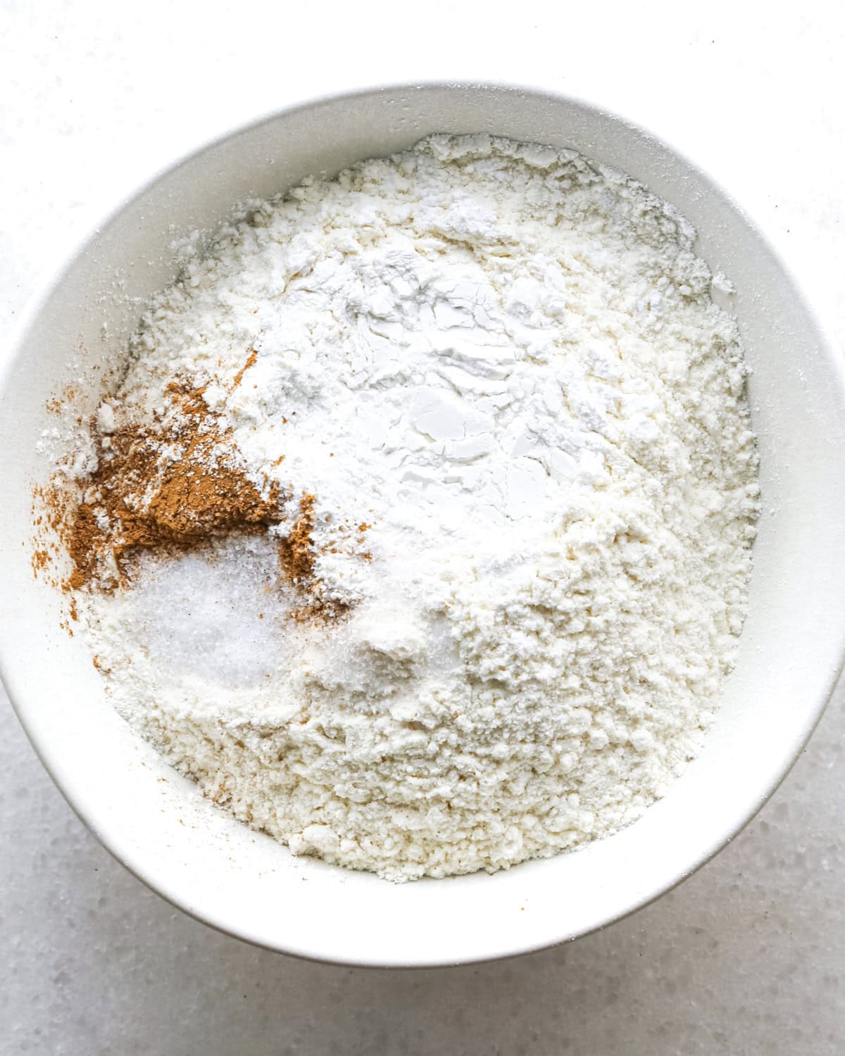 making blueberry muffins - dry ingredients in a white bowl before mixing