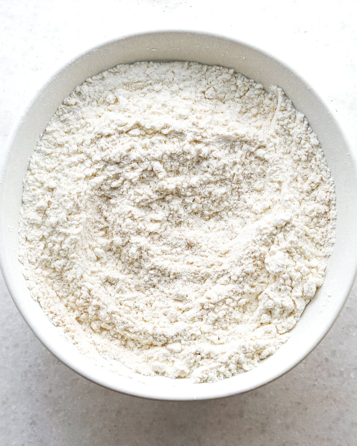 making blueberry muffins - dry ingredients in a white bowl after mixing