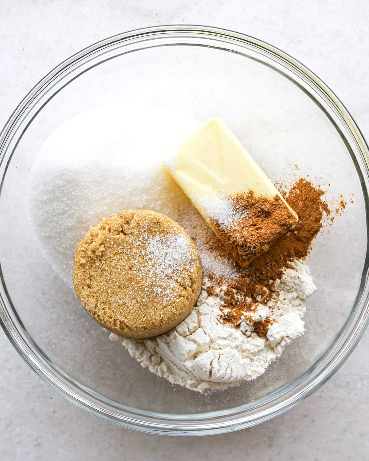 making the crumb topping for blueberry muffins - all ingredients in a glass bowl before mixing