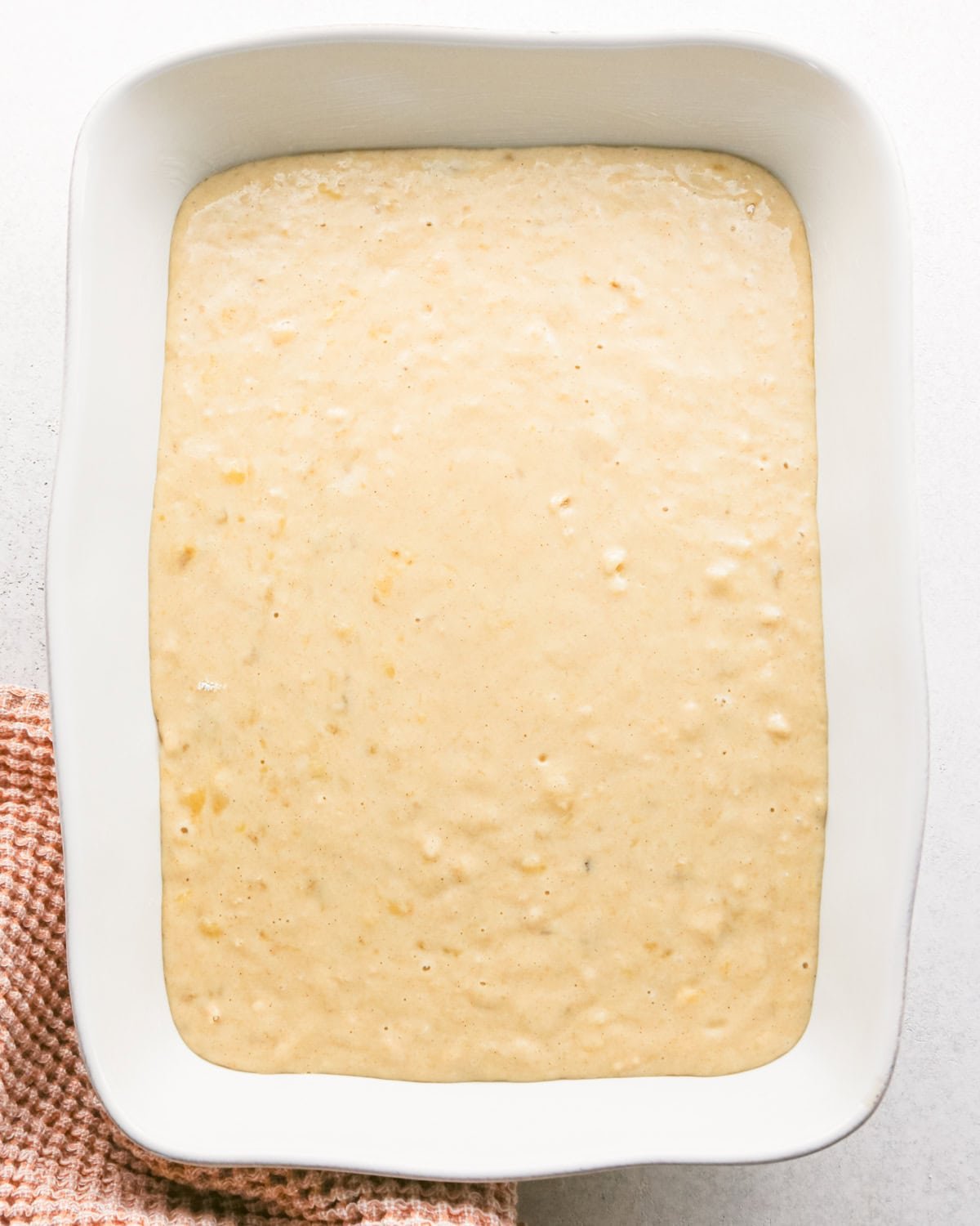 banana cake batter in a baking pan before baking