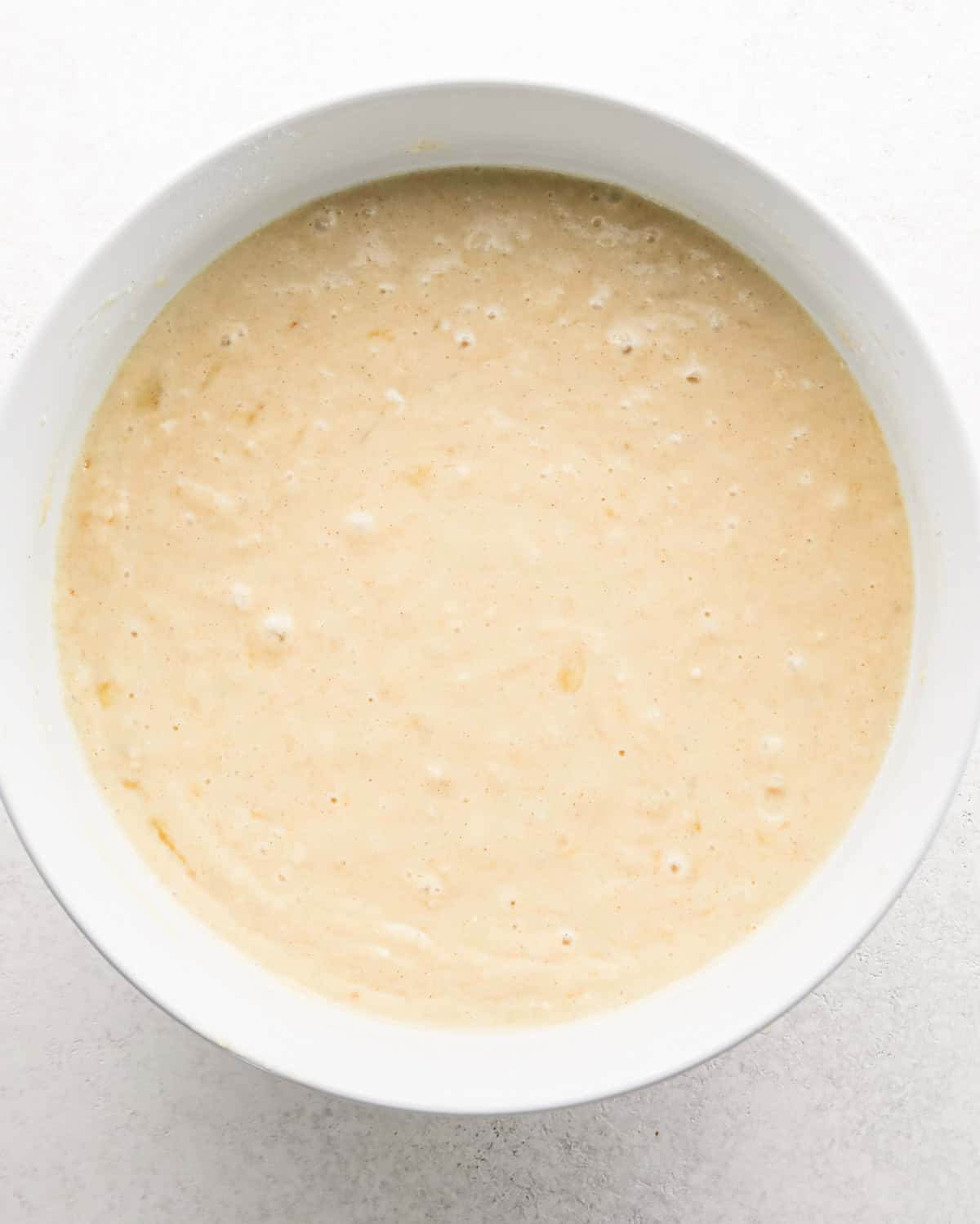 final banana cake batter in a white bowl