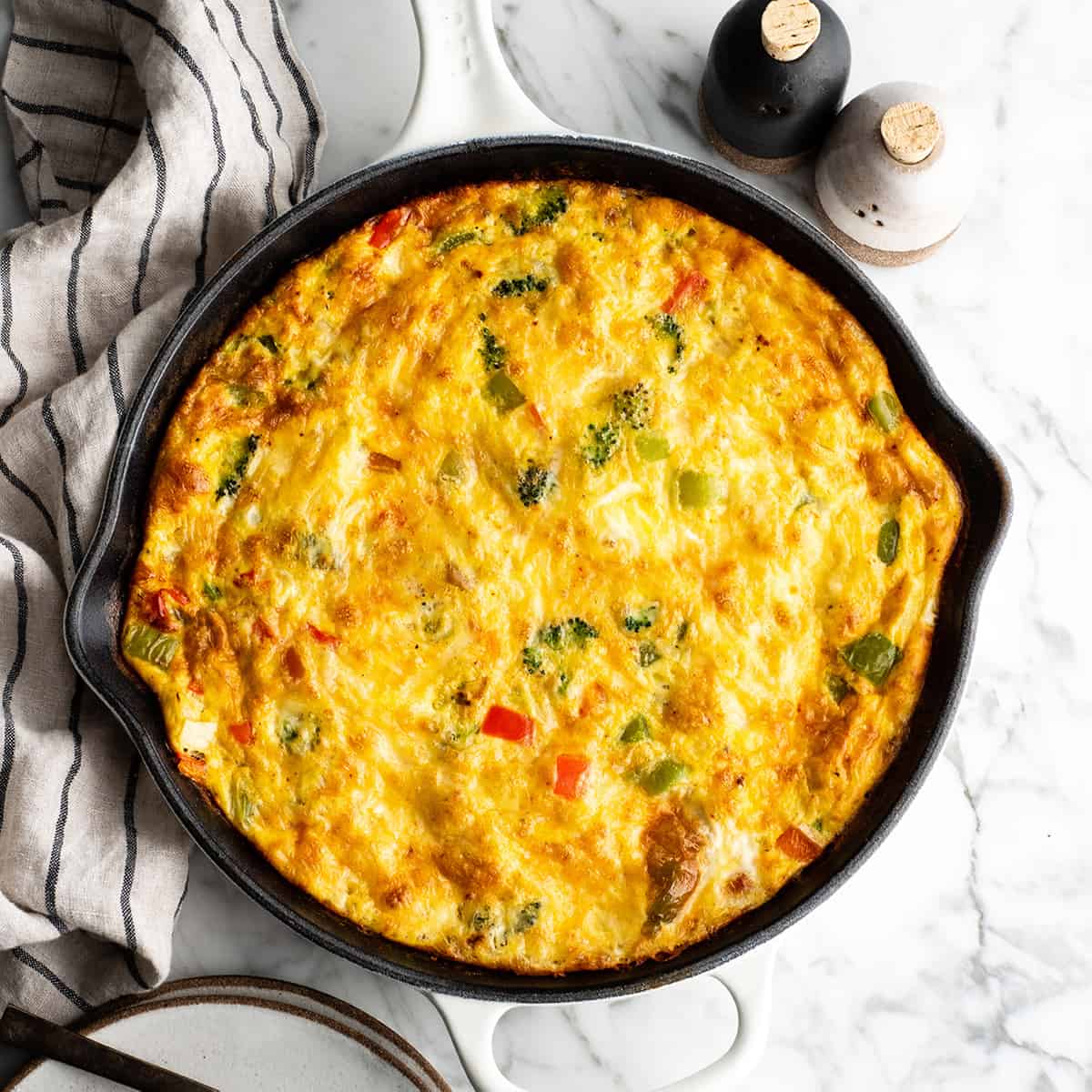overhead view of a vegetable frittata in a cast iron skillet