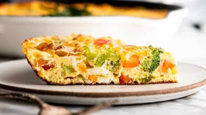 side view of a slice of frittata on a plate