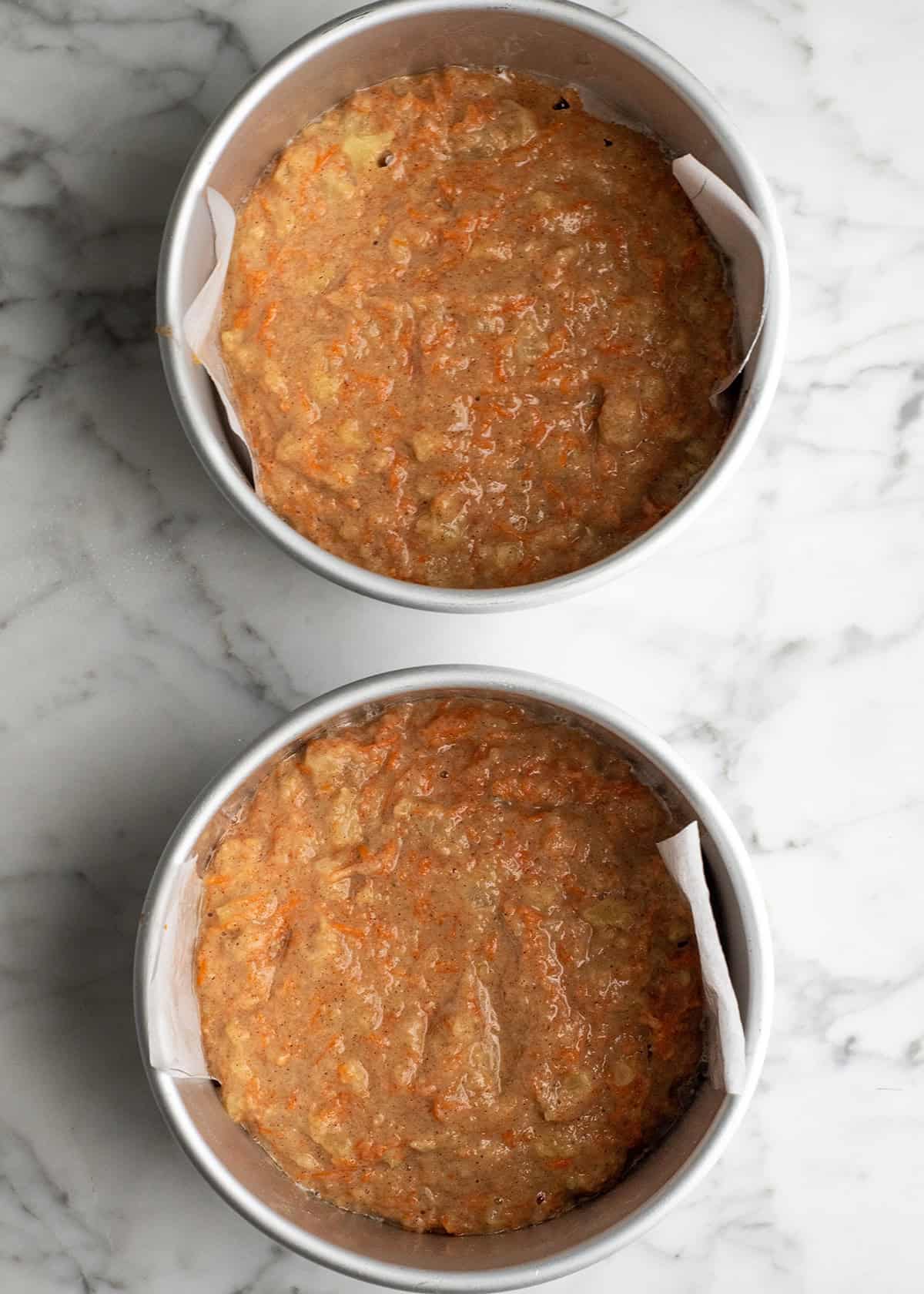 Healthy Carrot Cake batter in two cake pans before baking