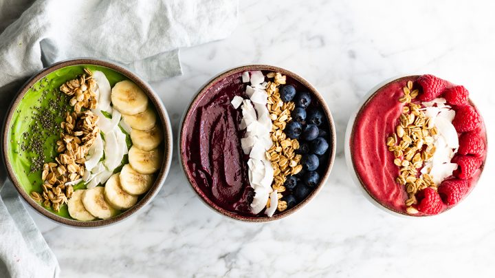 overhead view of 3 smoothie bowls in a row